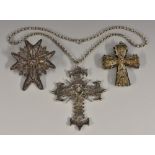 An unusual silver coloured reversible cross pendant necklace,