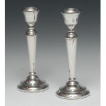 A pair of Elizabeth II silver candlesticks, bell shaped sconces, tapered pillars,