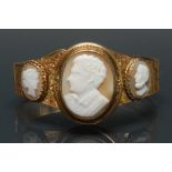 A 19th century carved shell cameo bracelet, central oval panel as a young gentleman facing right,