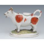 A 19th century Staffordshire cow creamer, standing four square, tan patch markings, oval base,