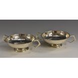 A pair of Arts and Crafts silver pedestal dishes, plainished overall, angular handles, 15cm wide,