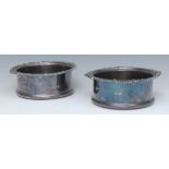 A pair of early 20th century silver plated wine coasters, draught turned bases,