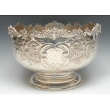 A Victorian style EP on copper circular pedestal punch bowl, embossed with flowers and foliage,