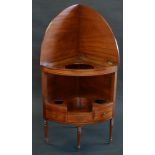 An unusual George III mahogany bow fronted corner washstand,