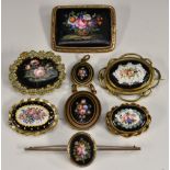 Brooches - a 19th century enamelled panel brooch, roses on black ground,