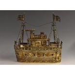 A silver coloured metal nef, as a battle ship, with masts, flags, canons and lifeboats,