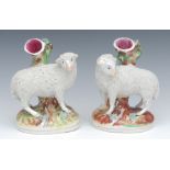 A pair of Staffordshire spill vases, of sheep, standing to the left and right, shredded clay coats,