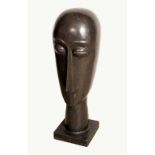 Modern School, a polished stone sculpture, stylised head, square base,