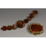 A 19th century banded agate elasticated bracelet, principle larger circular panel banded with red,