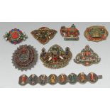 A Tibetan gau of ruyi shaped pendant brooch, four figural images of Bodhisattvas and Buddhas,