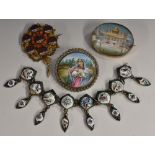 A late 19th century Anglo Indian oval painted brooch, temple and river scene, unsigned, ,