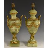 A pair of Louis XVI design gilt metal mounted green onyx pedestal urnular table laps,