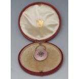 A gold coloured metal diamond and rose guilloche enamel circular pendant,