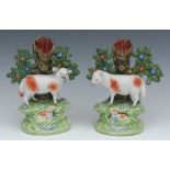 A pair of John Walton spill vases, with ram and lamb and ewe and lamb before bocage, 18cm high,