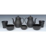 A Wedgwood basalt engine turned flared vase, 10cm high, impressed mark; two baluster coffee pots,
