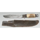 An early 20th century bowie knife, antler haft, leather scabbard,