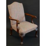A George III style mahogany Gainsborough armchair, outswept arms terminating in scrolls,