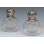 A pair of Victorian clear glass globular scent bottles,