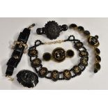 Jewellery - a Victorian jet panel bracelet, central gilt buckle; carved brooch; bracelet,