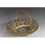 A George IV silver boat shaped swing handled cake dish, pierced and embossed with flowers,