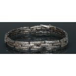 A diamond encrusted triple row line bracelet,