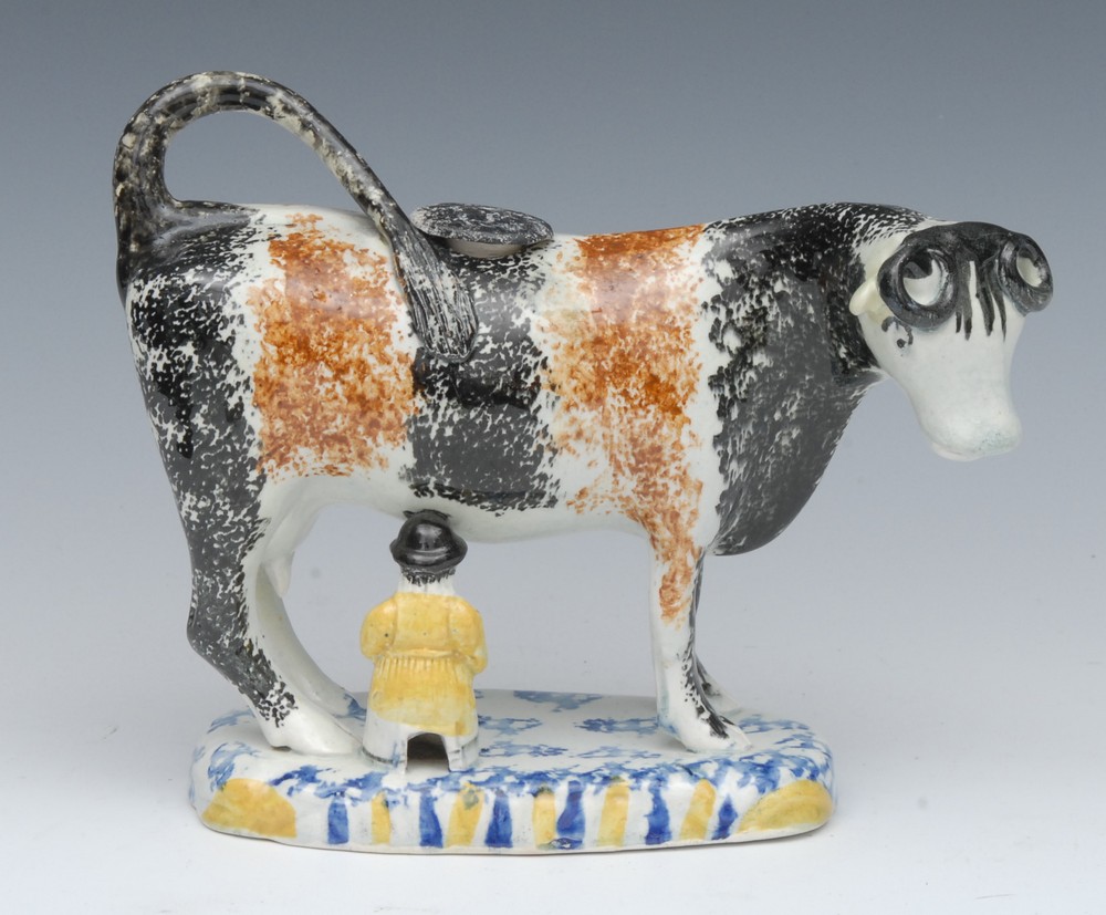 A 19th century Pearlware cow creamer, possibly Yorkshire, standing four square,