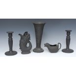 A pair of Wedgwood black basalt candlesticks, in relief with fruiting vine, reeded column, 21.