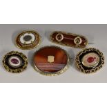 Brooches - a 19th century banded red and white agate mourning brooch, central woven hair work panel,