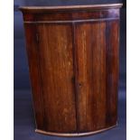 A George III oak and mahogany crossbanded bow front corner cupboard, moulded cornice, 99cm high,