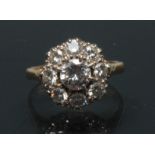 A diamond cluster ring, central round brilliant cut diamond approx 0.