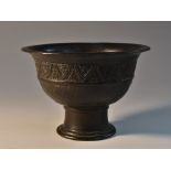 A Chinese bronze stem cup, flared rim above bands of lotus lappets and waves, circular foot,