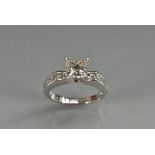 A contemporary princess cut diamond ring, central princess cut diamond approx 1.05ct, size approx 5.