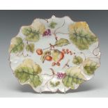 An early Derby grape and vine-moulded shaped dish, the centre painted with a ripe quince, cherries,