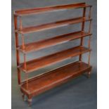 A 19th century mahogany five-tier waterfall bookcase, turned columns, brass casters, 116cm high,