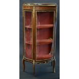 A Louis XVI style gilt metal and mahogany bow fronted display cabinet,