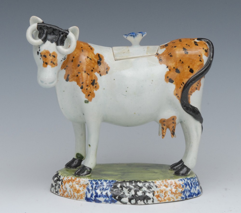 A 19th century Staffordshire Pearlware cow creamer, standing four square,