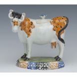 A 19th century Staffordshire Pearlware cow creamer, standing four square,