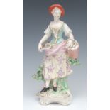 A Derby Patch Mark figure, of a Shepherdess, she stands, with flowers in her apron,