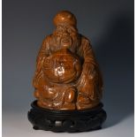 A Chinese bamboo figure, carved as a bearded immortal holding a peach, 15.