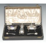 A George VI silver three piece condiment set, comprising mustard, salt and pepper,