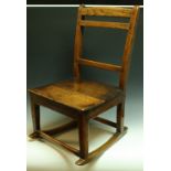 A late 18th/early 19th century oak and elm child's rocking chair