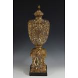 A Neo-Classical style fossil stone urn, pine cone finial, square plinth,
