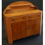 A Cotswold School oak sideboard, arched superstructure with plate rest and upstands,
