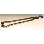 A pair of 19th century cast iron barley twist fire tongs, the handle modelled as a dragon,