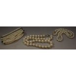 A single strand cultured pearl necklace, individually knotted creamy white pearls,