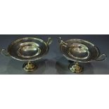 A pair of silver pedestal bon-bon dishes, each with two loop handles, knopped pedestal,