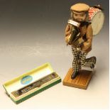 A Hohner advertising figure; a Hohner harmonica,