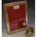 A silver rectangular photograph frame, London, 1999; another, small circular frame,