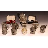 A silver plate three piece tea set; a Parks of London coaster, Arts and Crafts style,