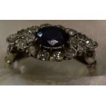 An Art Deco style diamond and deep blue sapphire effect doublet cluster ring,